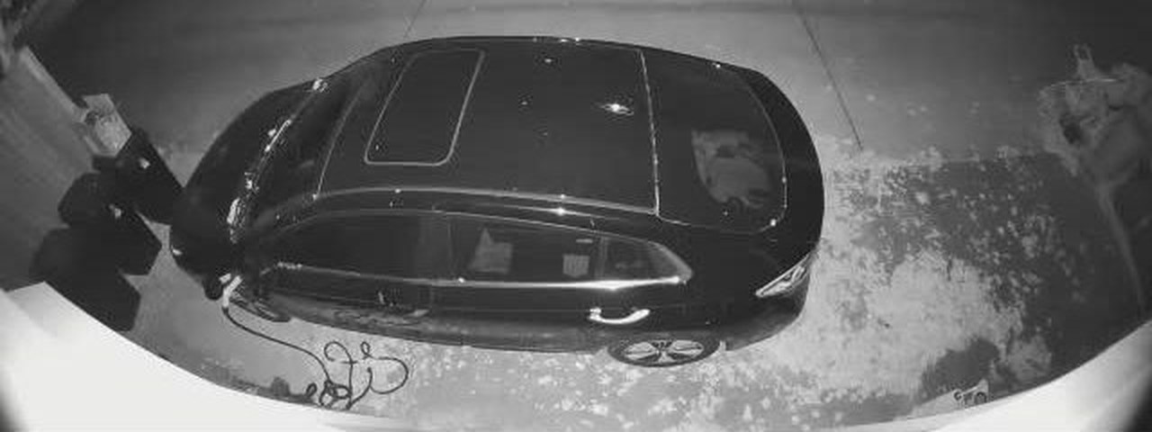 The night picture cropped to the lower part of the frame and enlarged to twice its size, so the car fills most of it